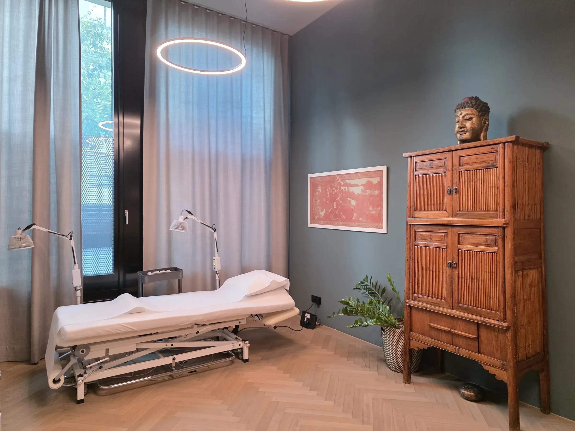 Treatment room with couch and Chinese cabinet